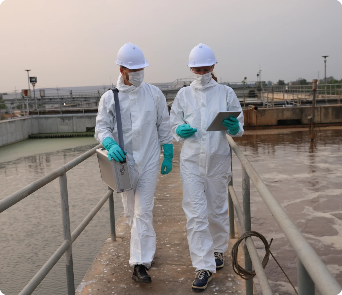 Workers in protective suits at wastewater plant
